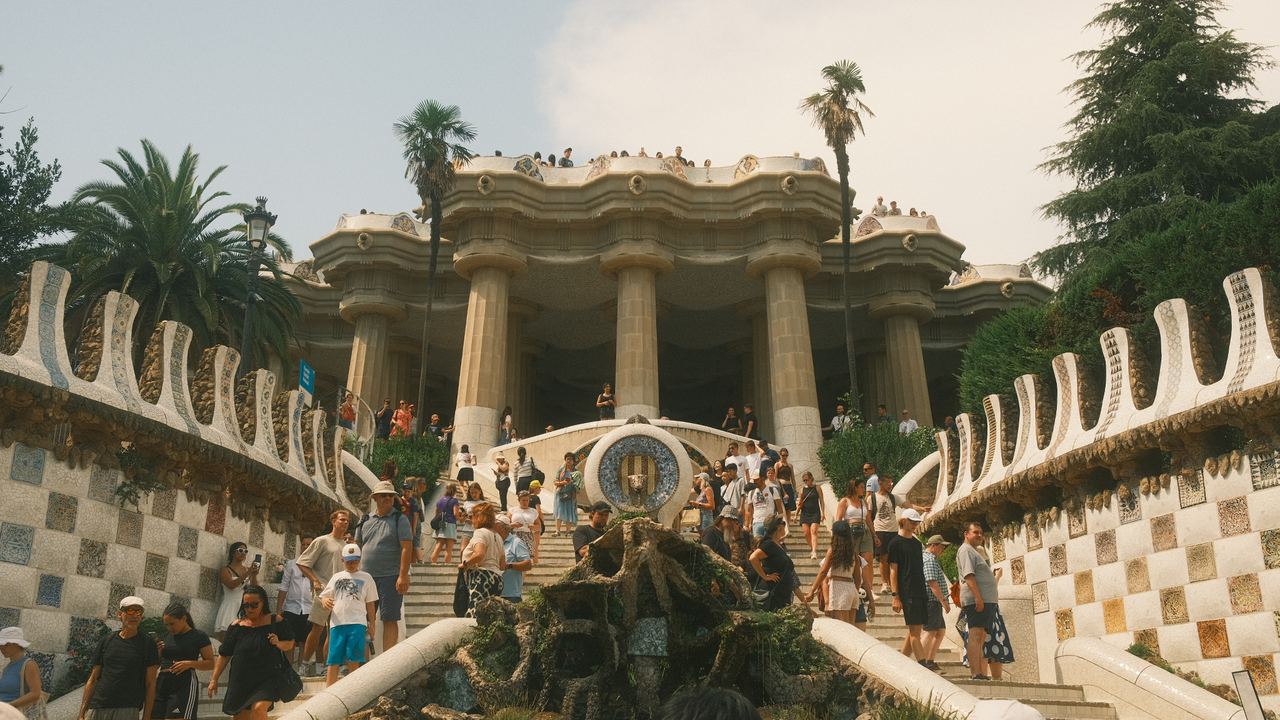 Crowds on the mosaic staircase below the columned hall at Park Guell, Barcelona