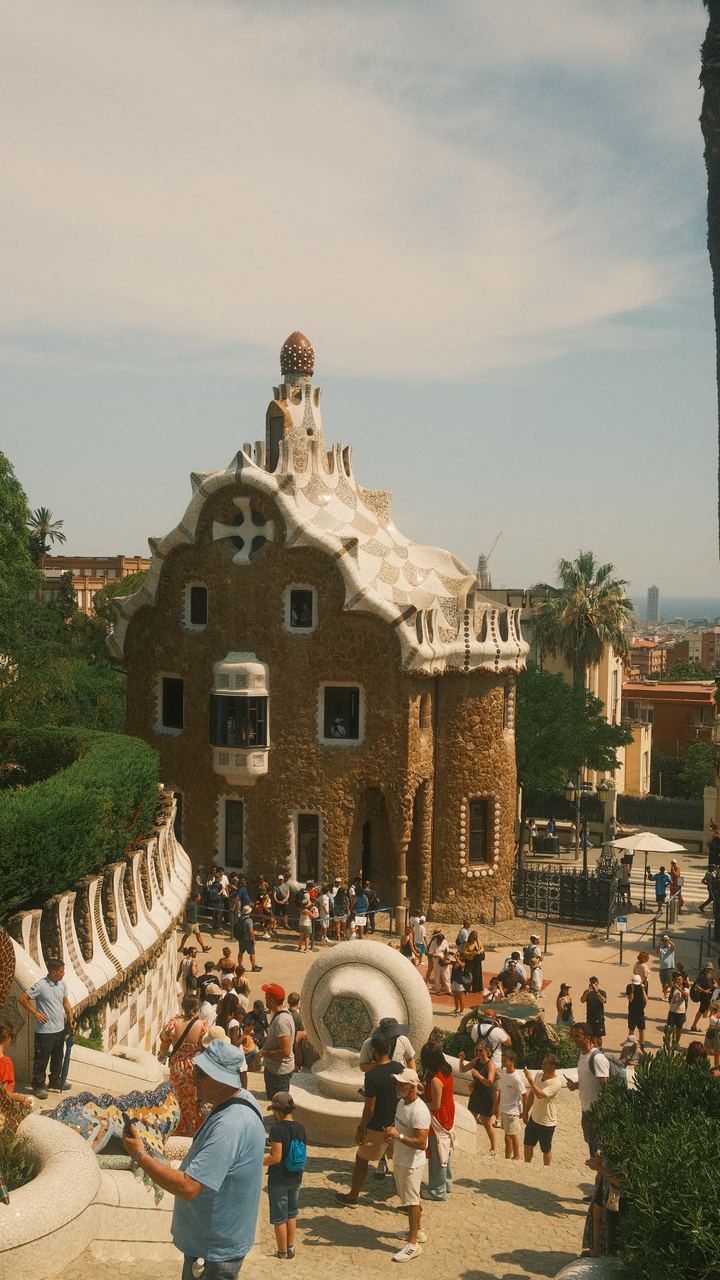 Gaudi's mosaic gatehouse rising above the crowds at Park Guell, Barcelona